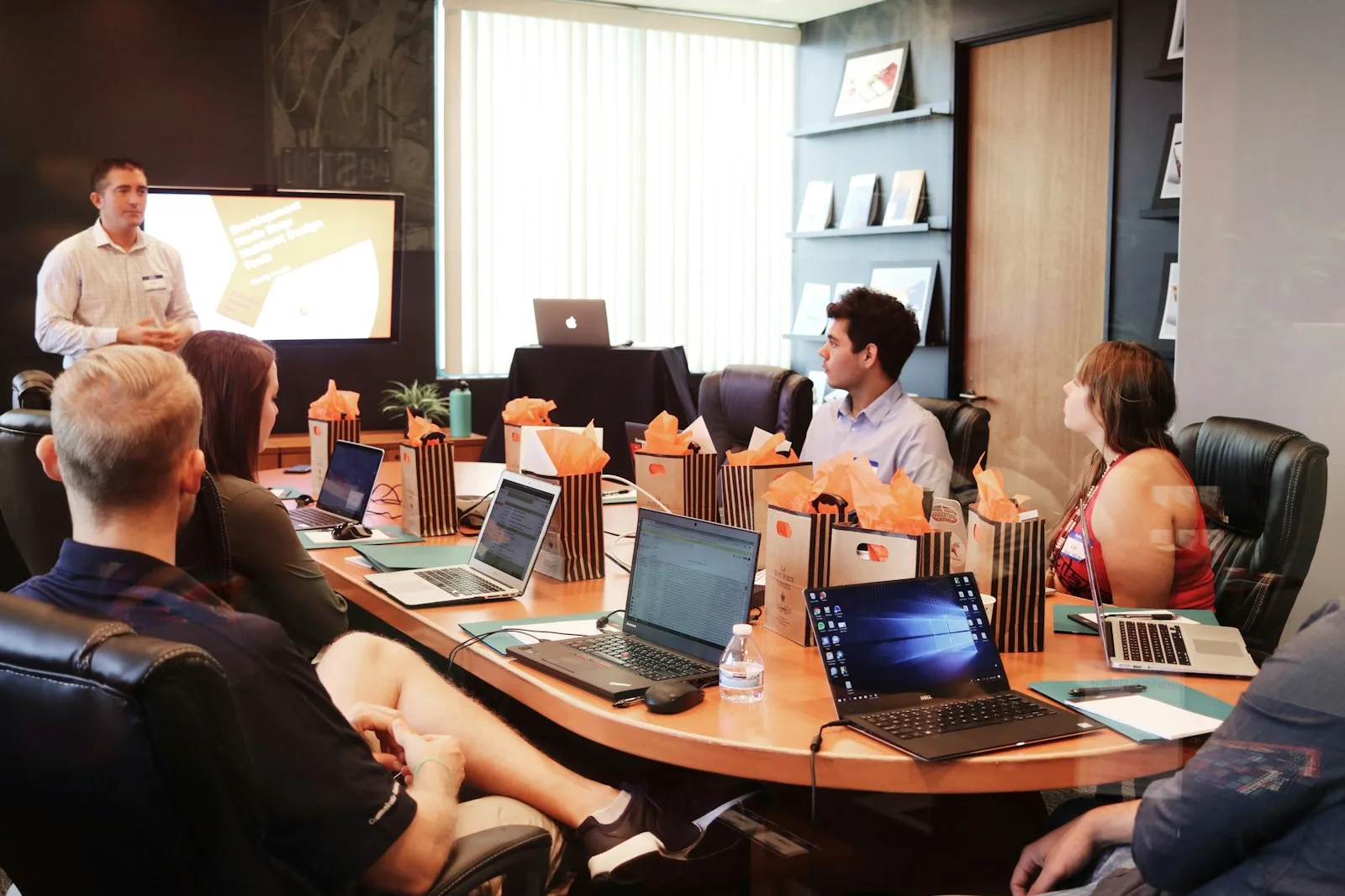 A cybersecurity leader presenting capability coverage and workforce risk to executives in a boardroom