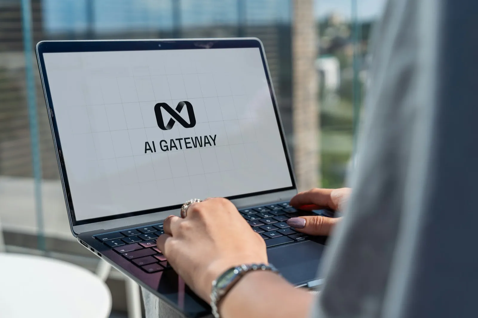 A professional working on a laptop displaying an AI interface, representing a workforce that now blends people and AI agents